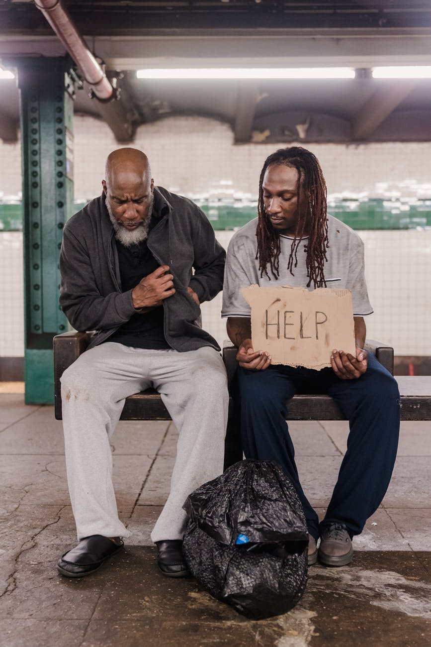 man and woman sitting on bench