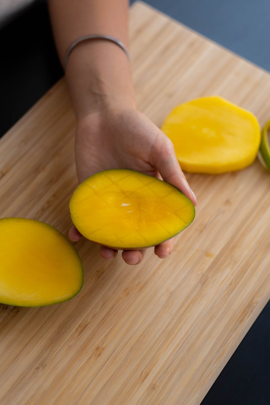 person holding yellow fruit