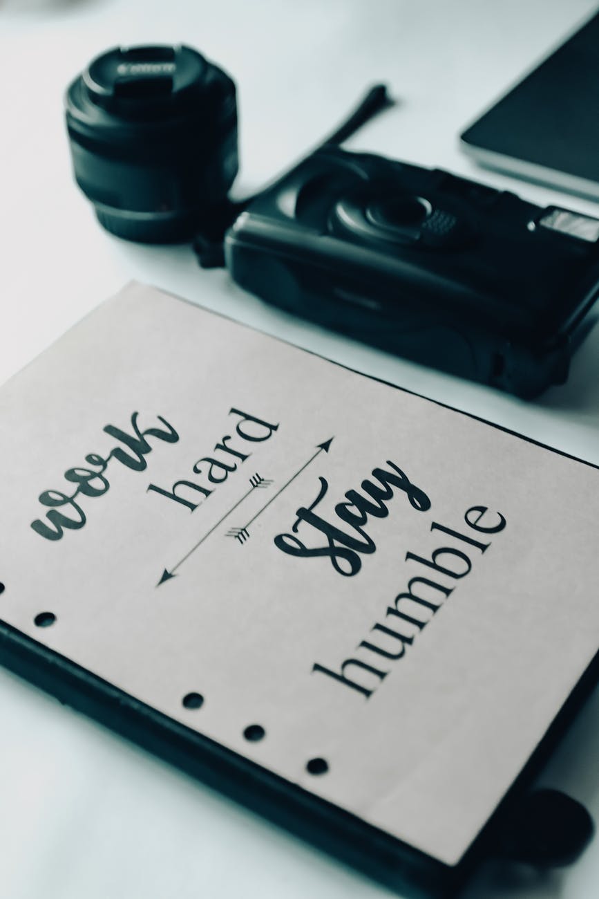 notebook and photo camera on table