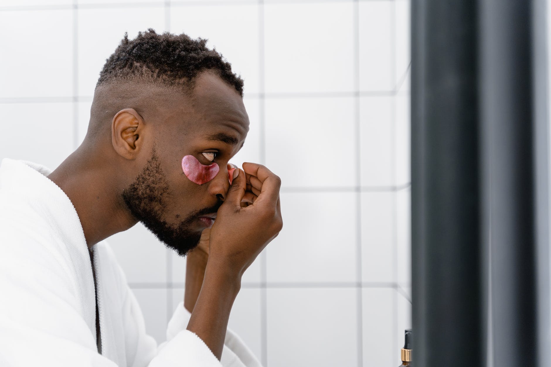 man putting eye patches under eye